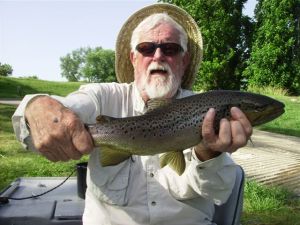 Bill proudly displays his hefty 22 inch brown.